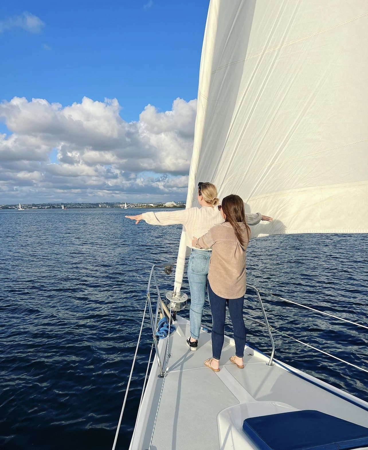 A guest on the bow watching for wildlife under sail