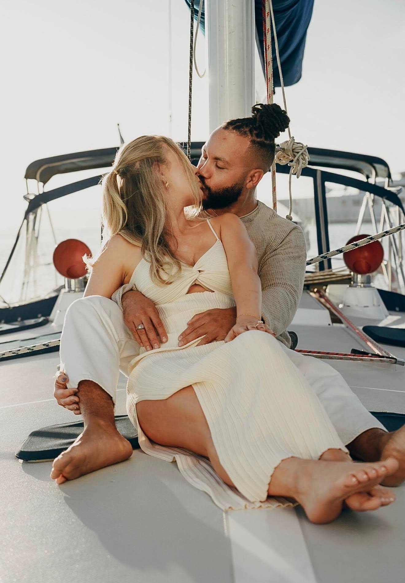 A couple sitting close together on the foredeck of the Mojave