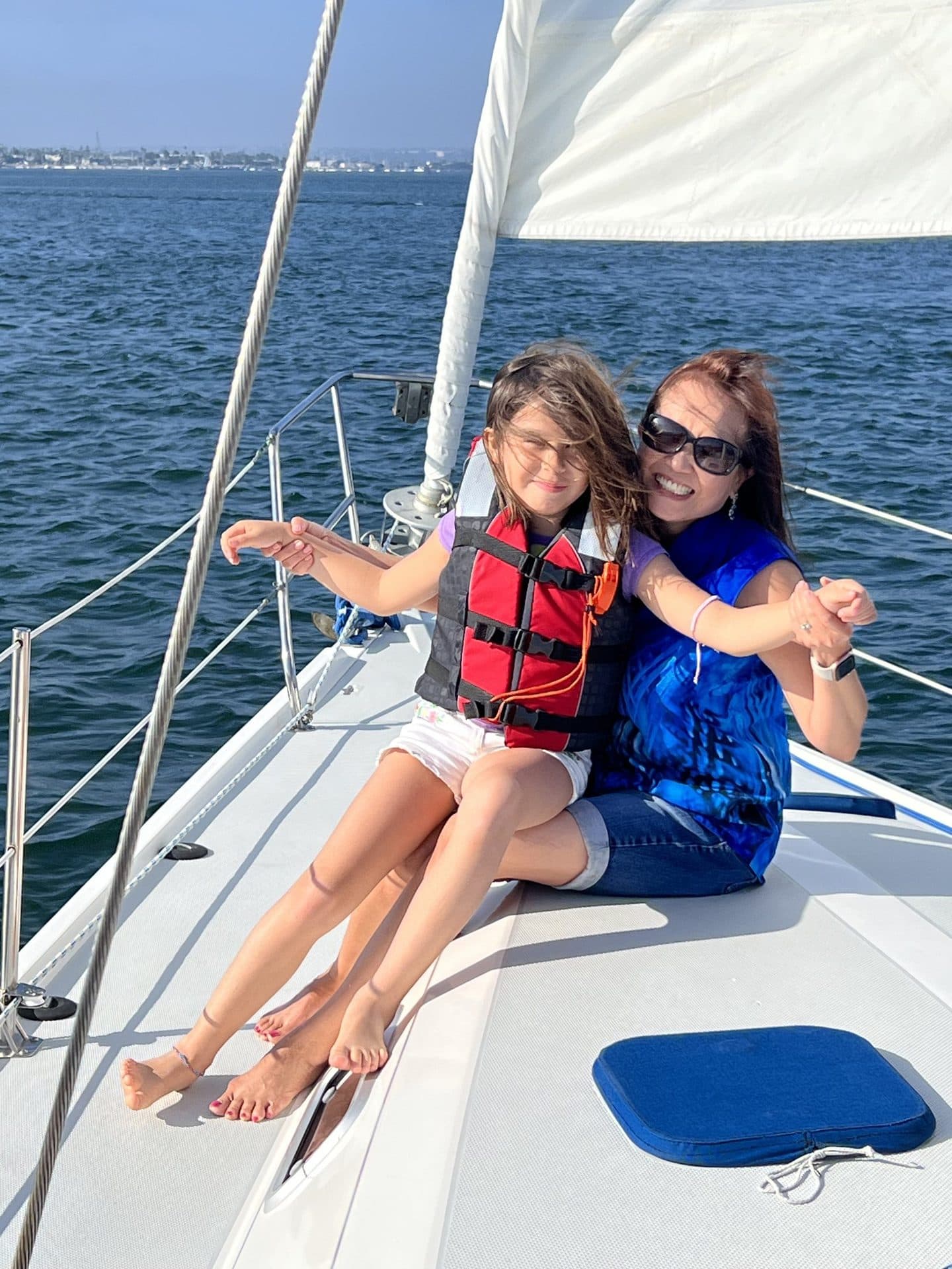 A family with children in life jackets on the bow of the Mojave on San Diego Bay