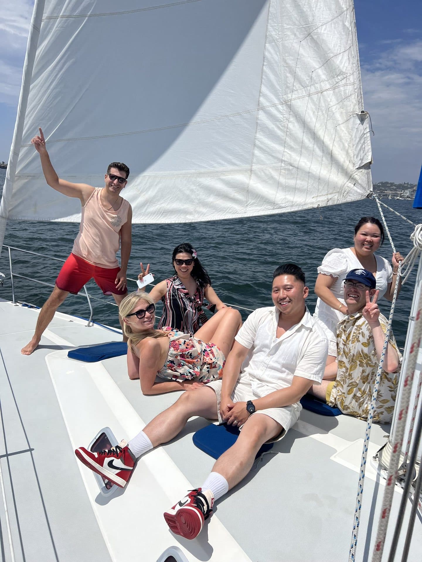Friends relaxing on the bow of the Mojave under sail on San Diego Bay