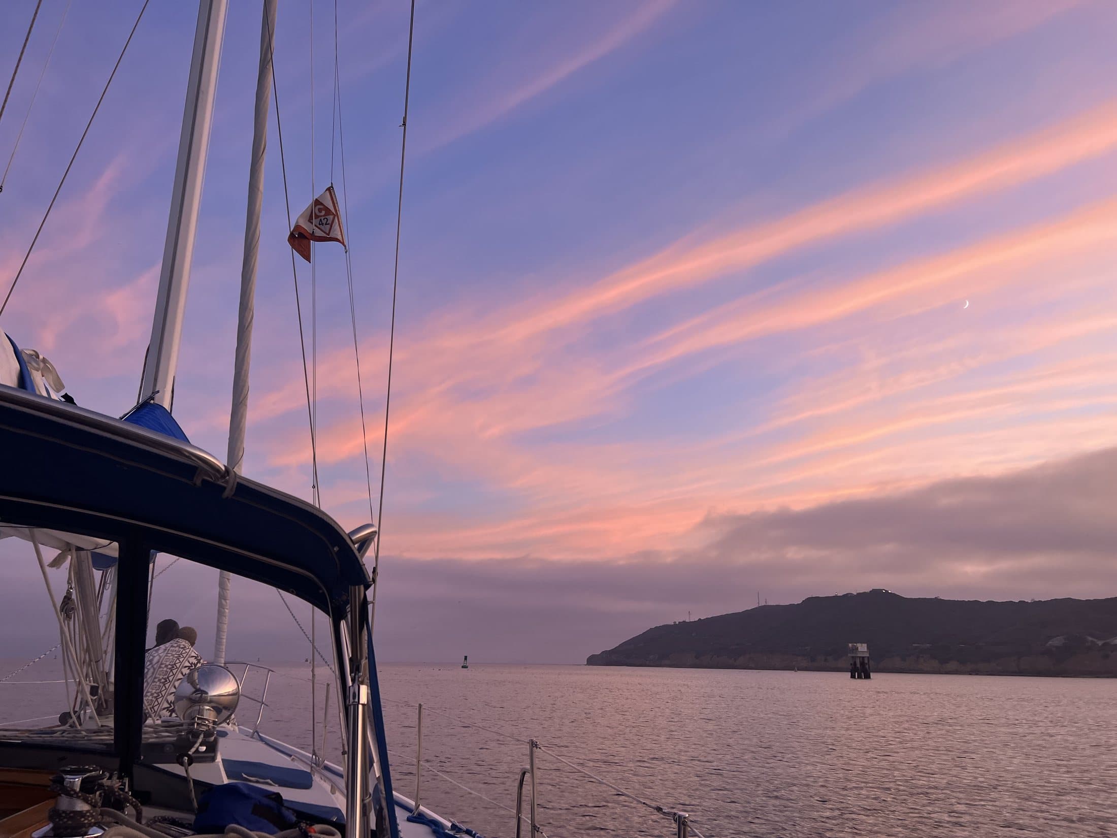 A soft pastel sunset over calm San Diego Bay in the off-season